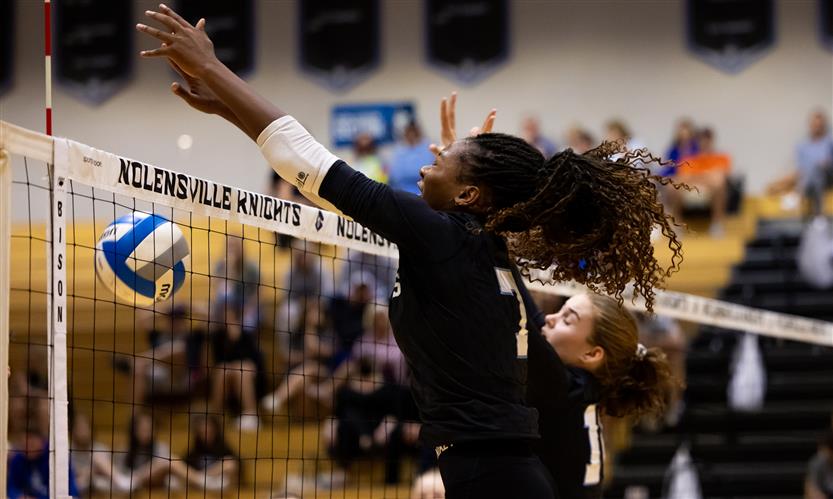 High school students play volleyball